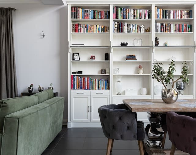 a-living-dining-room-with-a-large-bookshelf