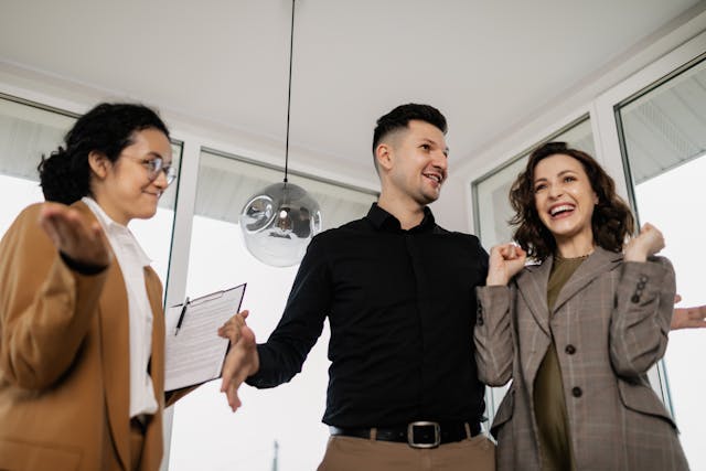 happy-couple-celebrating-with-a-professional-holding-a-clipboard