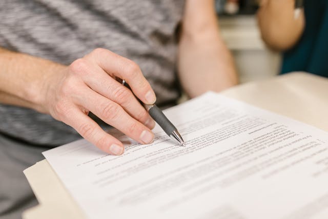 pexels-rdne-7841833 person using a pen and reading a document