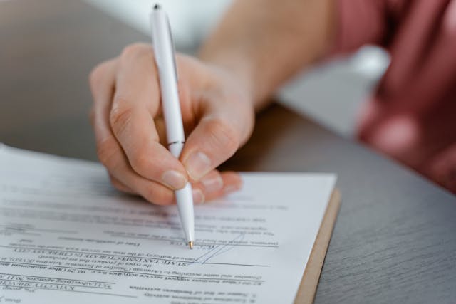 person-signing-document person-signing-document